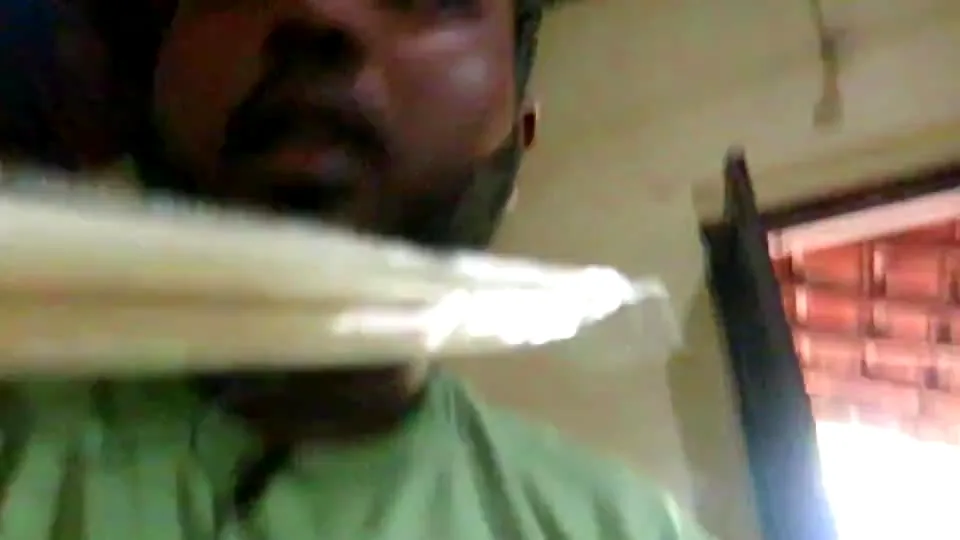 A blurred handheld frame with motion and warm indoor light.